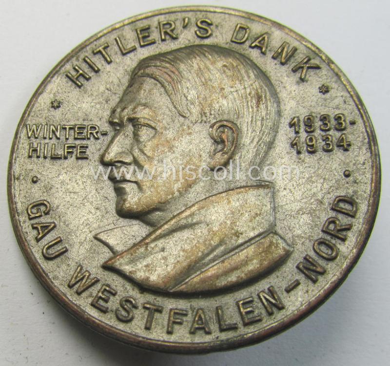 Commemorative, silvered 'Buntmetall'-based N.S.D.A.P.- (ie. WHW-) related 'tinnie' being a maker- (ie. 'Paulmann u. Crone'-) marked example depicting Adolf Hitler and showing the text: 'Hitler's Dank - Winterhilfe 1933-1934 - Gau Westfalen-Nord'