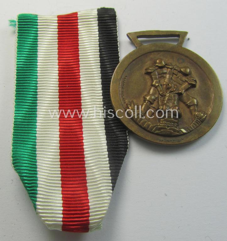 Attractive, golden-bronze-coloured- (and I deem 'Buntmetall'-based-) example of a: 'Deutsch-Italienische Feldzugsmedaille' (or: German-Italian campaign-medal) that came together with its (broader-sized- ie. Italian-produced) piece of original ribbon