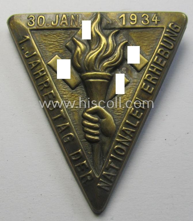 Commemorative, golden-bronze-coloured N.S.D.A.P.-related 'tinnie' being a non-maker-marked example depicting a hand holding a torch surrounded by the text: '1. Jahrestag der Nationalen Erhebung - 30. Jan. 1934'