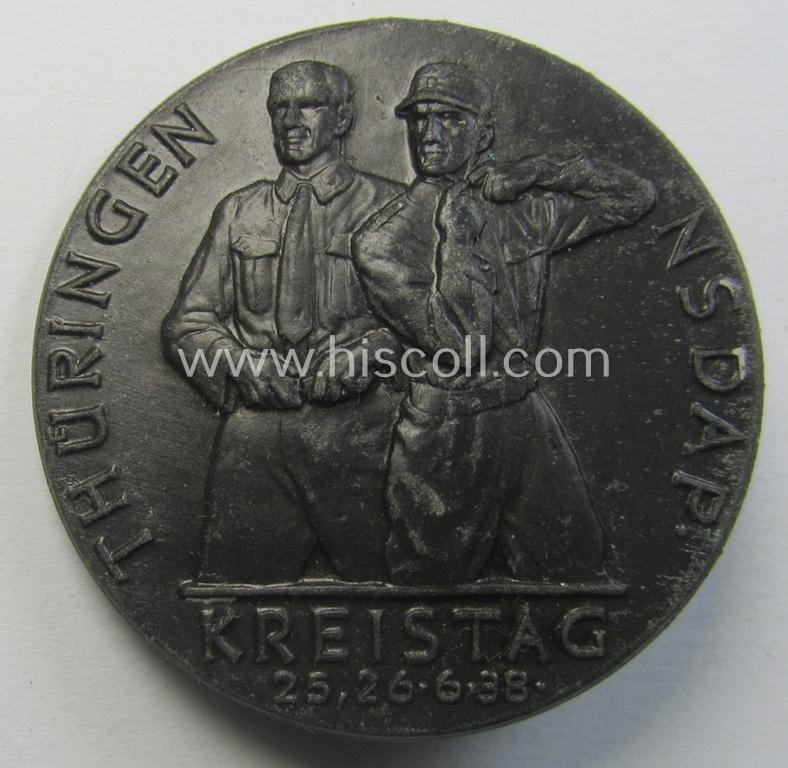 Commemorative, 'N.S.D.A.P.'-related 'tinnie' being a maker- (ie. 'G. Danner - Mühlhausen/Thür.'-) marked example depicting two N.S.D.A.P.-members coupled with the text: 'Thüringen - Kreistag N.S.D.A.P. - 25.26.6.1938'