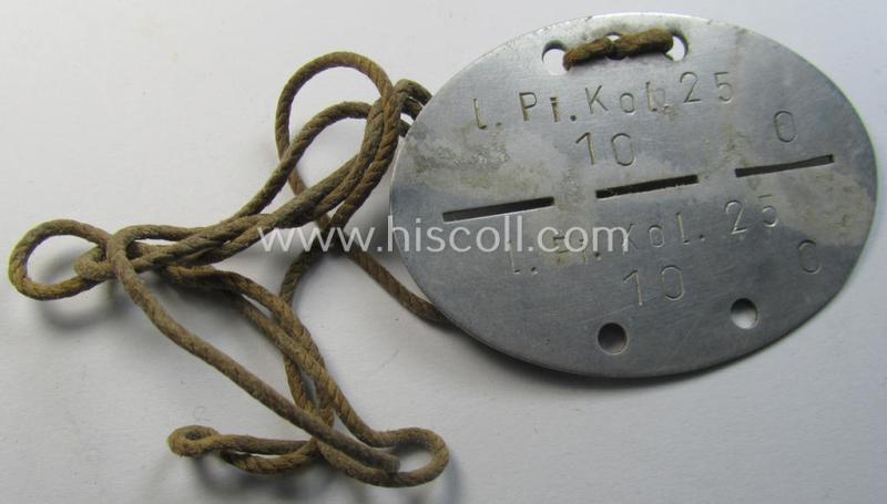 Aluminium-based, WH (Heeres) ie. 'Pioniere'-related ID-disc bearing the clearly stamped unit-designation that simply reads: 'l.Pi.Kol. 25' and that comes mounted on its period cord as issued and worn