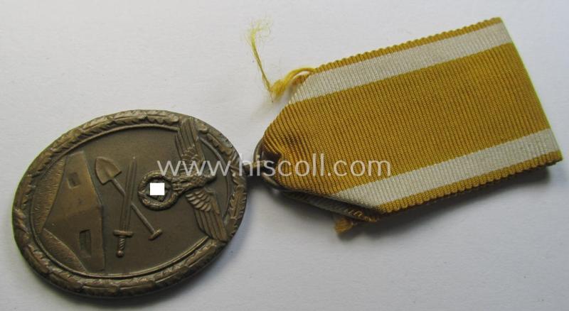 Medal-set: 'Deutsches Schutzwall Ehrenzeichen' (aka: 'Westwall'-medal) being a non-maker-marked- and/or: 'Buntmetall'-based specimen that comes mounted onto its period- (and neatly folded ie. pre-confectioned) ribbon (ie. 'Bandabschnitt')