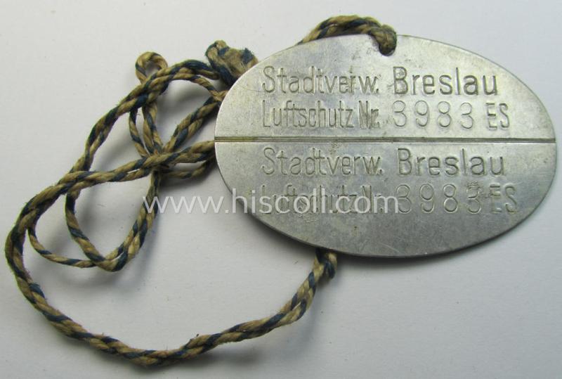 Very unusual, aluminium-based RLB- (ie. 'Reichs-Luftschutzbund'-) related ID-disc bearing the clearly stamped unit-designation that simply reads: 'Stadtsverw. Breslau - Luftschutz Nr. 3983 ES' and that comes mounted onto  its period cord