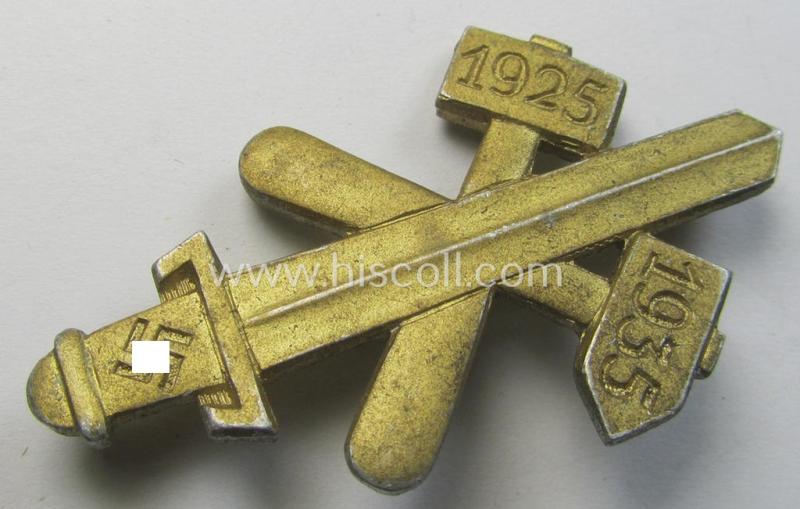 Commemorative, golden-coloured, N.S.D.A.P.-related 'tinnie' being a maker- (ie. 'Hofstätter - Bonn'-) marked example depicting a detailed, upright-positioned sword and two 'hammers' and swastika and bearing the dates: '1925 - 1935'