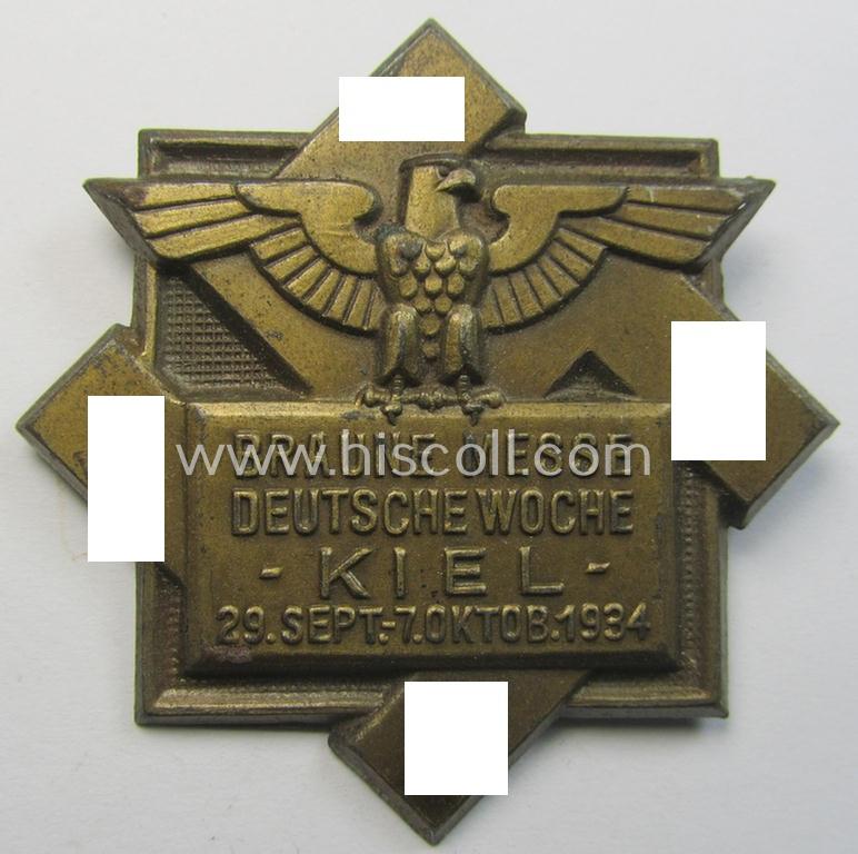 Commemorative, golden-bronze-coloured N.S.D.A.P.-related 'tinnie' being a non-maker-marked example depicting a 'Reichsadler' and large swastika coupled with the text: 'Braune Messe - Deutsche Woche - Kiel - 29. Sept.-7. Oktob. 1934'