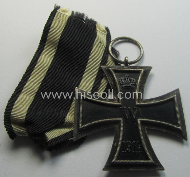 Attractive, WWI-period: 'Eisernes Kreuz II. Klasse' (or: iron cross second class) being a maker- (ie. 'KO'-) marked example that comes together with its (minimally) confectioned piece of ribbon (ie. 'Bandabschnitt')