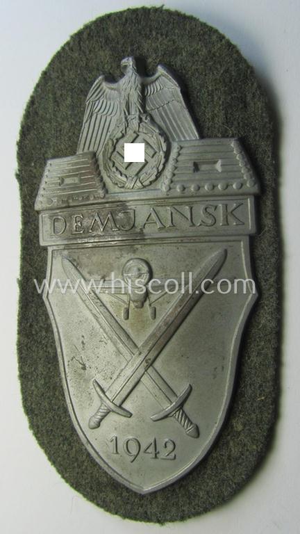 Attractive example of a - fairly scarcely encountered! - WH (Heeres ie. Waffen-SS) 'Demjansk'-campaign-shield as executed in typical magnetic metal (ie. so-called: 'Eisenblech') and that comes in an overall very nice- ie. fully untouched, condition