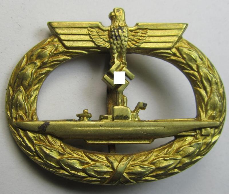 Attractive - albeit moderately worn! - WH (Kriegsmarine) 'U-Bootkriegsabzeichen' being a non-maker-marked example as executed in bright-golden-toned 'Buntmetall' (ie. 'Tombak') as was produced by the maker (ie. 'Hersteller'): 'Schwerin - Berlin'