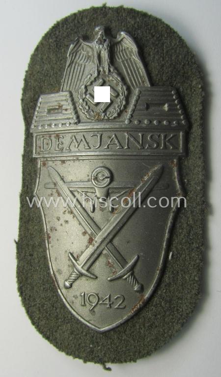 Superb example of a - fairly scarcely encountered! - WH (Heeres ie. Waffen-SS) 'Demjansk'-campaign-shield as executed in typical magnetic metal (ie. so-called: 'Eisenblech') and that comes in an overall very nice- ie. fully untouched, condition