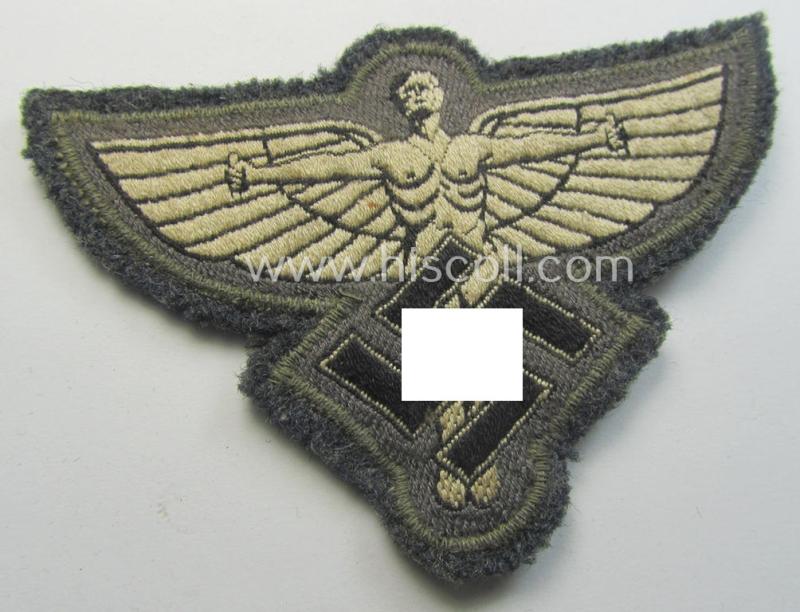 Attractive, bluish-grey-coloured, so-called: N.S.F.K.- (or: 'National Socialistisches Flieger Korps') breast-badge being a nicely BeVo-woven- (and enlisted-mens'-pattern) example that comes mounted on its piece of bluish-coloured wool