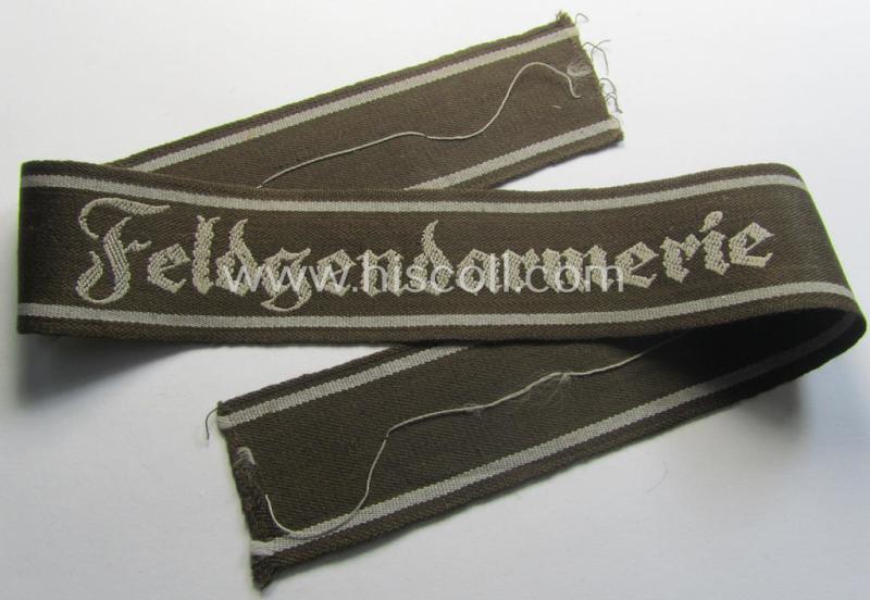 Superb - and scarcely encountered! - example of a WH (Heeres) cuff-title ie. armband (ie. 'Ärmelstreifen') entitled: 'Feldgendarmerie' (being a typical 'semi-BeVo'-woven!) example that comes in a full length- ie. non-shortened, condition