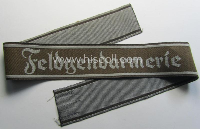 Superb - and scarcely encountered! - example of a WH (Heeres) cuff-title ie. armband (ie. 'Ärmelstreifen') entitled: 'Feldgendarmerie' (being a typical 'BeVo'-woven!) example that comes in a full length- ie. non-shortened, condition