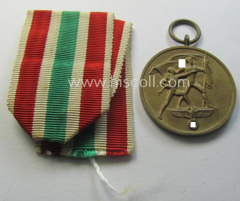 Superb, WH Memelland 'Anschluss'- (ie. occupation-) medal: '22 März 1939' (being a minimally used example of the so-called: 'slanted G'-type) that comes together with its original non-confectioned (albeit shortened) ribbon (ie. 'Bandabschnitt')