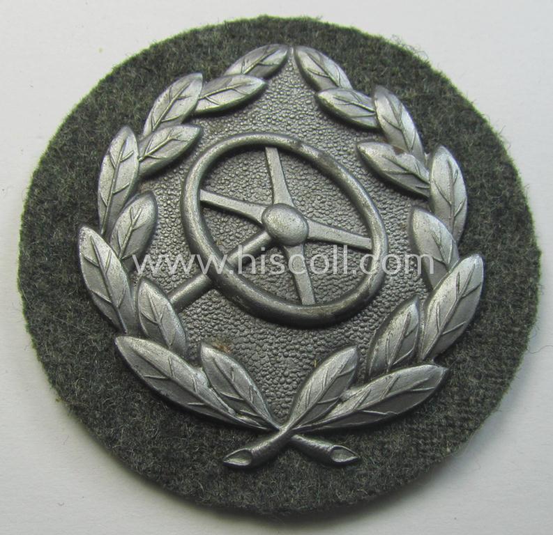 Superb, WH (Heeres- ie. Waffen-SS) so-called: 'Kraftfahrbewährungs-Abzeichen in Silber' (or: silver-class drivers' proficiency-badge) that comes mounted onto its piece of field-grey-coloured wool and that comes as issued- but never worn, condition