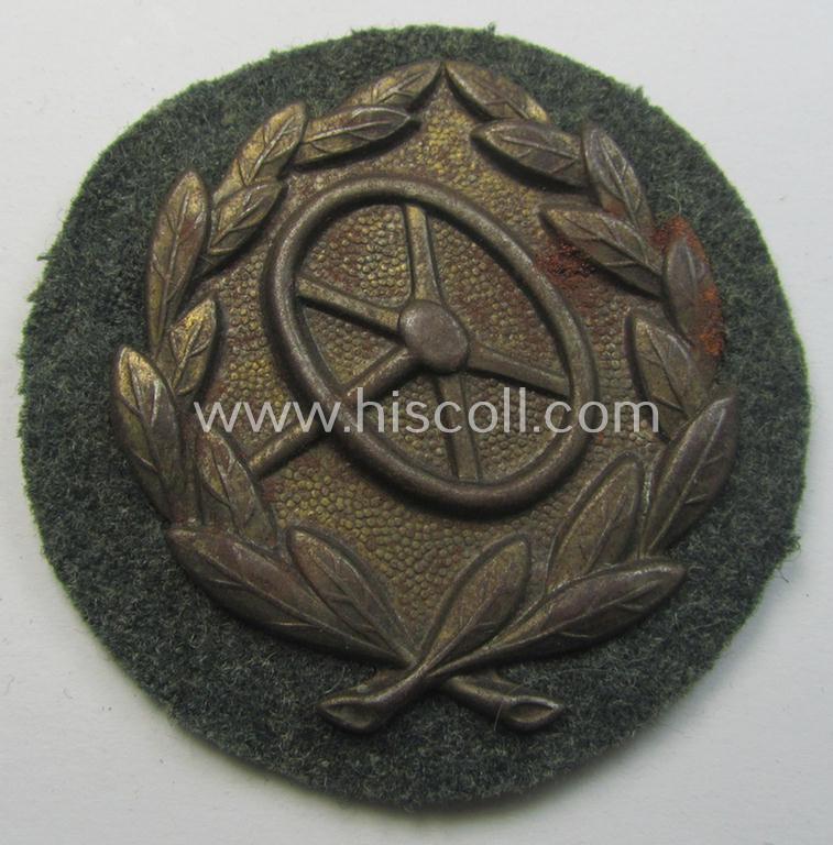 Superb, WH (Heeres- ie. Waffen-SS) so-called: 'Kraftfahrbewährungs-Abzeichen in Bronze' (or: bronze-class drivers' proficiency-badge) that comes mounted onto its piece of field-grey-coloured wool and that comes as issued- but never worn, condition