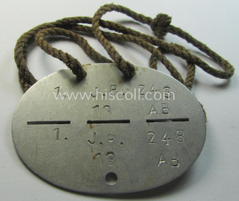 Aluminium-based, WH (Heeres) ie. 'Infanterie'-related ID-disc bearing the clearly stamped unit-designation that simply reads: '1.J.R. 248' and that comes mounted on its period cord as issued and/or worn