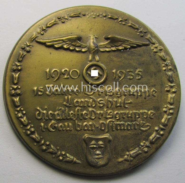 Commemorative, bright-golden-toned 'N.S.D.A.P.'-related 'tinnie' depicting an N.S.D.A.P.-party-eagle and surrounded by the text: '15 Jahre Ortsgruppe Landshut - die älteste Ortsgruppe i. Gau bay. Ostmark - 1920 -1935'