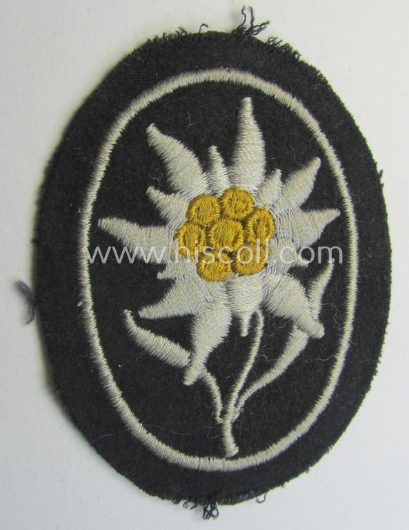 Neat - and I deem truly used and/or worn! - Waffen-SS-pattern, black-coloured sleeve-insignia (ie. 'Ärmelabzeichen') depicting an: 'Edelweiss'-flower as used by the various 'Gebirgsjäger'- (ie. mountain-troops-) related divisional-staff