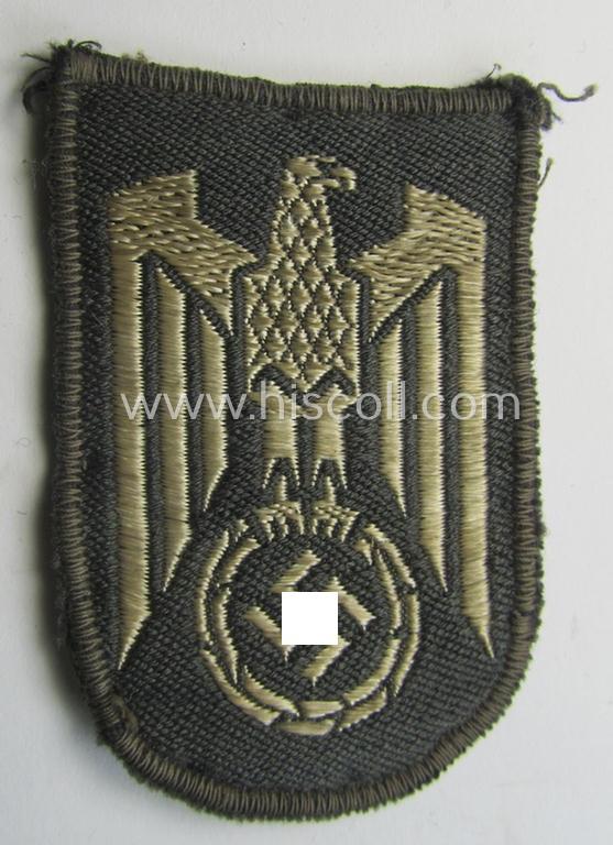 Attractive - and actually scarcely encountered! - example of a 'BeVo'-woven, German Red Cross ('DRK' or: 'Deutsches Rotes Kreuz') tunic eagle-device (ie. 'Ärmeladler') to be worn on the various DRK-tunics and/or uniforms