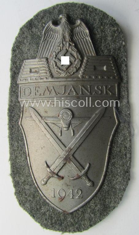 Superb - and fairly scarcely encountered! - example of a WH (Heeres ie. Waffen-SS) 'Demjansk'-campaign-shield as executed in typical magnetic metal (ie. so-called: 'Eisenblech') and that comes in an overall very nice- ie. fully untouched, condition