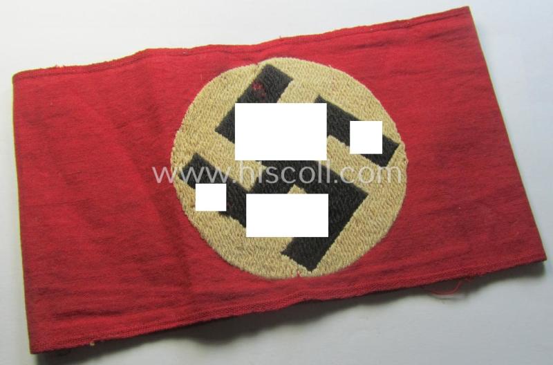 Attractive - and just moderately used! - so-called: N.S.D.A.P.-related party-armband (ie. 'Armbinde') being of the 'entirely woven'-pattern showing an interwoven ie. 'machine-embroidered' swastika (ie. roundel)