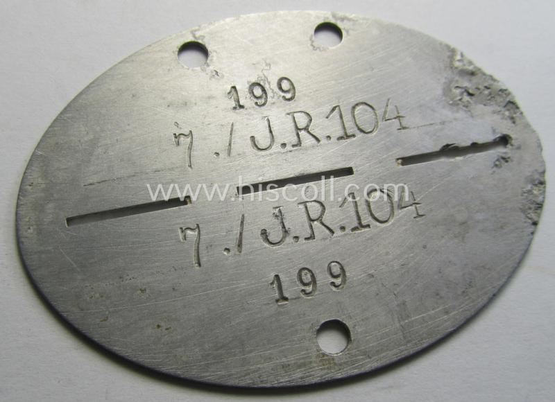 Aluminium-based, WH (Heeres) ie. 'Infanterie'-related ID-disc bearing the clearly stamped unit-designation that simply reads: '7./J.R.104' and that comes as issued and/or worn