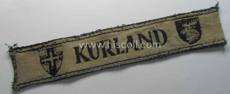 Superb, full-length example of a WH (Heeres ie. Kriegsmarine) cuff-title- ie. armband (ie. 'Ärmelstreifen') entitled: 'Kurland' that comes in an overall very nice- (albeit clearly used- ie. tunic-removed-), condition