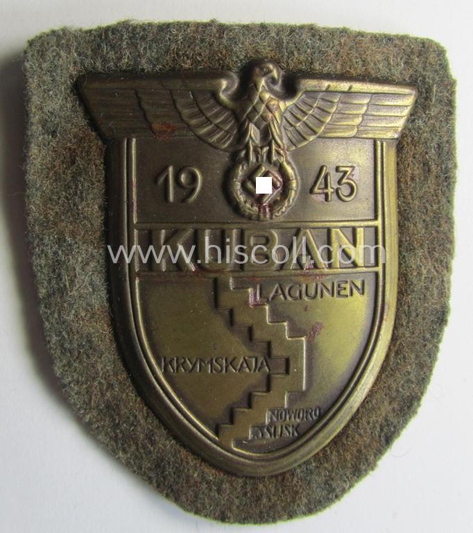 Attractive - truly worn and actually scarcely encountered! - WH (Heeres ie. Waffen-SS) 'Kuban'-campaign-shield that comes mounted onto its original field-grey-coloured- and/or woolen-based 'backing' as issued and/or used