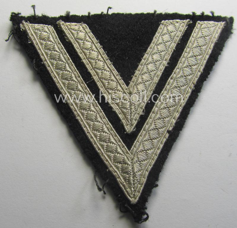 Neat - and just moderately used! - Waffen-SS- (ie. Heeres Panzer-) type 'Armwinkel' (or: rank-chevron) as executed on black-coloured wool as was intended for an: 'SS-Rottenführer' (ie. 'Obergefreiter')