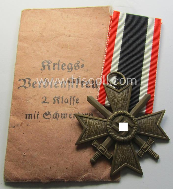 Superb medal-set: 'KvK 2. Klasse mit Schwertern' being a clearly maker- (ie. '34'-) marked specimen by the maker- (ie. 'Hersteller') named: 'Willy Annetsberger' and that comes packed in its original  'Zellstoff'-based pouch