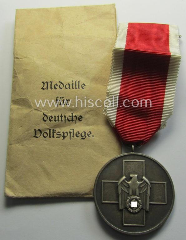 Attractive medal-set: 'Medaille für Deutsche Volkspflege' being a typical non-maker-maker-marked specimen that comes packed in its original pouch of issue by the: 'Hauptmünzamt Wien'-company as issued and/or recently found