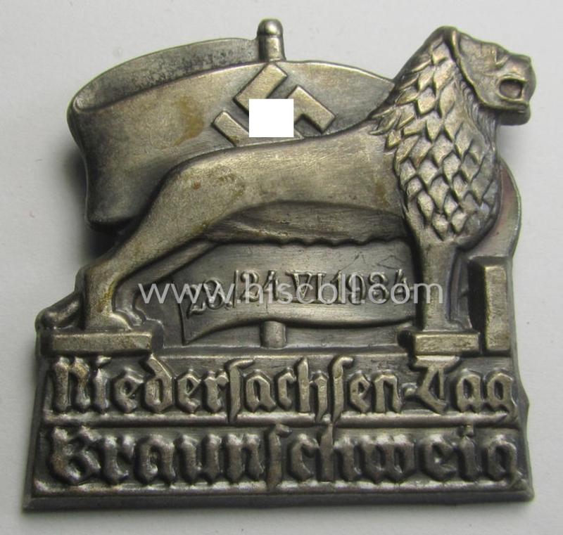 Silver-toned- & early-period 'N.S.D.A.P.'-related day-badge (ie. 'tinnie' or: 'Veranstaltungsabzeichen') being a non-maker-marked example depicting a lion and swastika-flag coupled with the text: 'Niedersachsen-Tag - Braunschweig - 23./24.VI.1934'