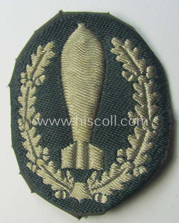 Superb - and rarely encountered! - 'BeVo'-woven version of a WH (Heeres) so-called: trade- and/or special-career insignia as intended for a: 'Nebelwerfer Richtkannonier' (or: qualified smoke-troops canon-operator) that comes in a used condition