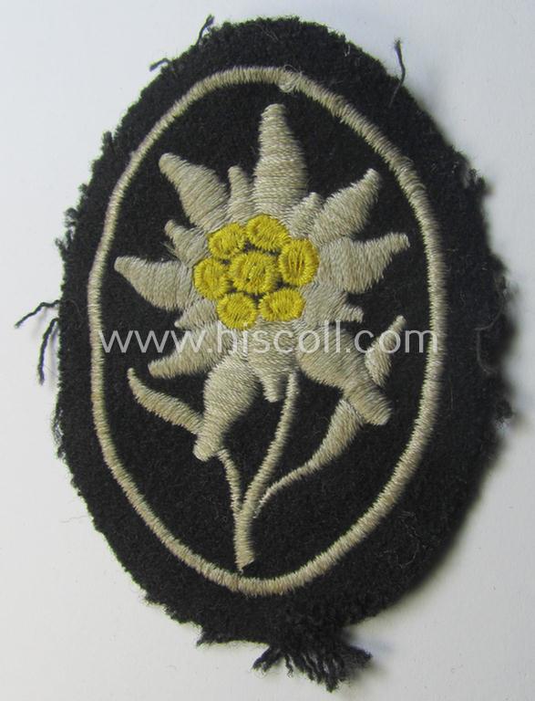 Neat - and I deem truly used and/or worn! - Waffen-SS-pattern, black-coloured sleeve-insignia (ie. 'Ärmelabzeichen') depicting an: 'Edelweiss'-flower as used by the various 'Gebirgsjäger'- (ie. mountain-troops-) related divisional-staff