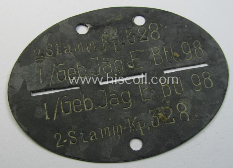 Superb - and truly scarcely found! - typical zinc-based, WH (Heeres-) ie. 'Gebirgsjäger'-related ID-disc (ie. 'Erkennungsmarke') bearing the clearly stamped unit-designation that reads: '2./Stamm Kp. 328 - I / Geb.Jg.Ers.Btl. 98'