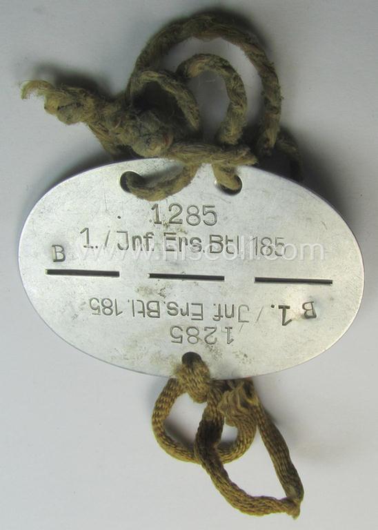 Aluminium-based, WH (Heeres) ie. 'Infanterie'-related ID-disc bearing the clearly stamped unit-designation that simply reads: '1./Inf.Ers.Btl. 185' and that comes mounted on its period cord(s) as issued and/or worn