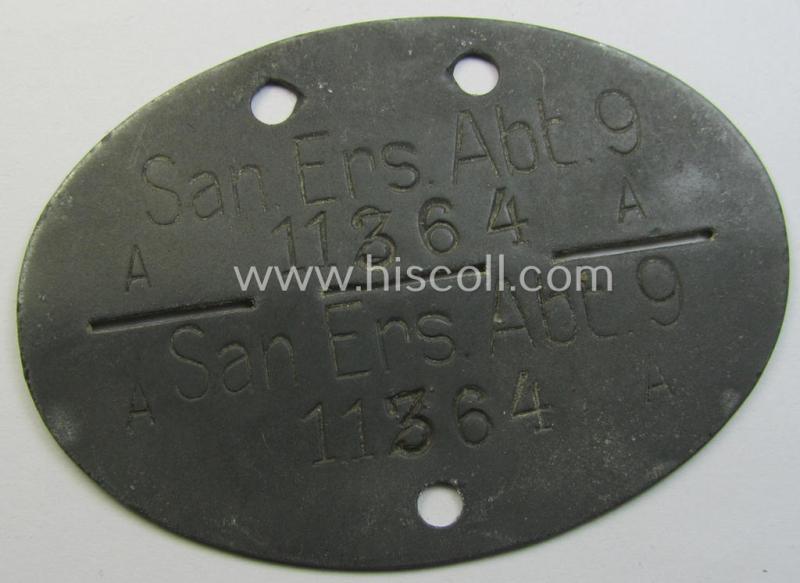 Greyish-toned and typical zinc-based, WH (Heeres) ie. 'Sanitäter'-related ID-disc bearing the clearly stamped unit-designation that simply reads: 'San.Ers.Abt. 9' and that comes as issued- and/or worn