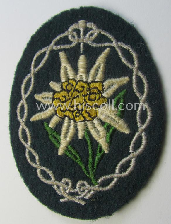 Truly used and/or tunic-removed, WH (Heeres) EM- (ie. NCO-) type, so-called: 'Edelweiss'-armpatch being a machine-embroidered example as was executed on darker-green wool as was specifically intended for usage by the: 'Gebirgsjäger-Truppen'