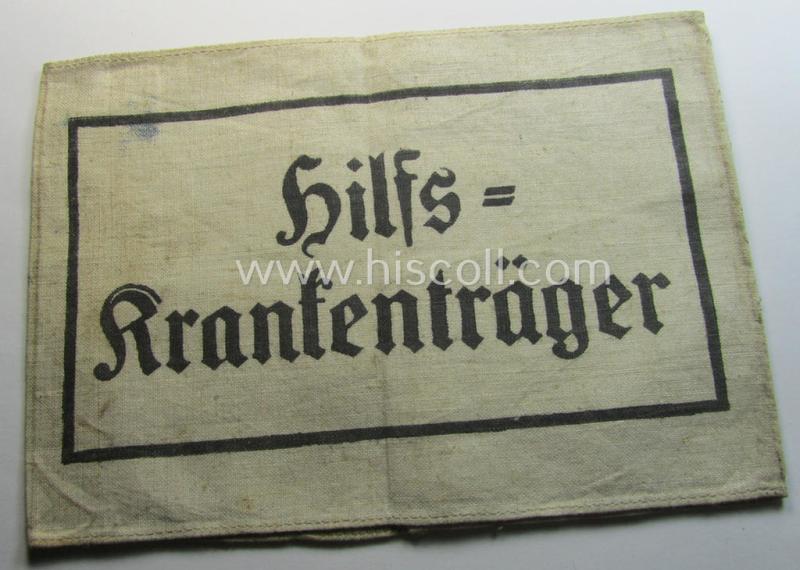 Neat, beige/white-coloured- and/or linnen-based armband (ie. 'Armbinde') as was executed in the 'thicker-styled' fabric as was intended for WH (Heeres) staff-members working as: 'Hilfs-Krankenträger'