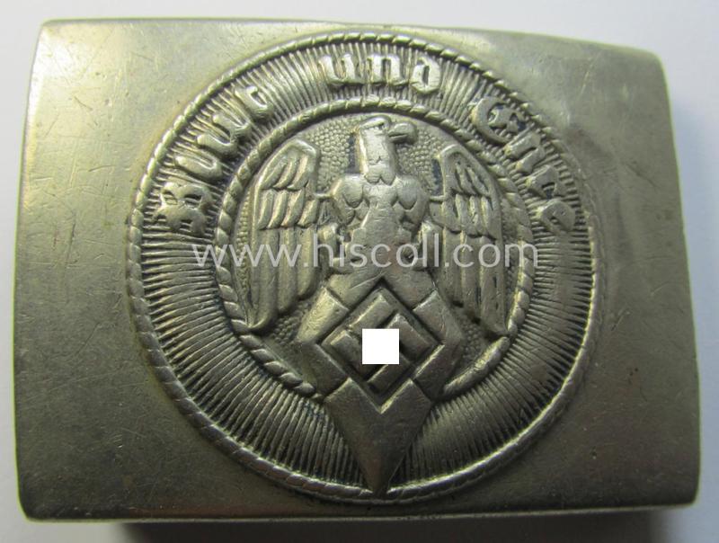 Truly used HJ (ie. 'Hitlerjugend') bright-silver-coloured- (ie. nickle-chrome-based and early-pattern) belt-buckle being a neatly maker- (ie. 'Ges.Gesch.'-) marked example that comes in a moderately used- ie. clearly worn condition