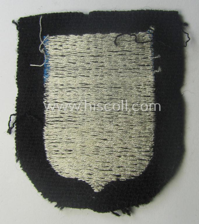 Waffen-SS 'volunteer'-arm-shield as was intended for usage by soldiers of the: '20. Waffen-Grenadier-Division der SS' (ie. 'estnische Nr. 1') and that comes in a 'virtually mint- ie. unissued', condition