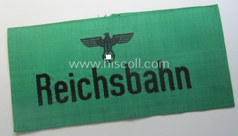 DRB- (ie. 'Deutsche Reichsbahn'-) related armband entitled: 'Reichsbahn' being of the 'entirely-woven'-type onto (typical) silk-like cloth in a technique similar to the 'BeVo'-weave pattern