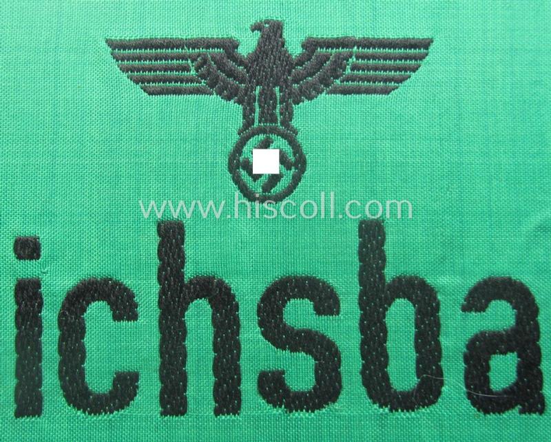DRB- (ie. 'Deutsche Reichsbahn'-) related armband entitled: 'Reichsbahn' being of the 'entirely-woven'-type onto (typical) silk-like cloth in a technique similar to the 'BeVo'-weave pattern