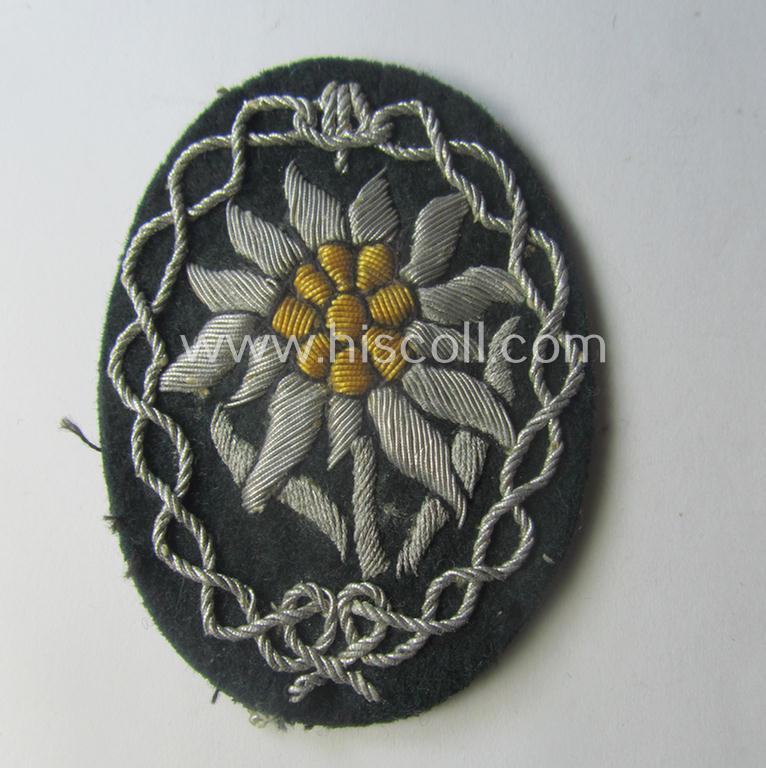 Moderately used, WH (Heeres) neatly hand-embroidered- and/or typical officers'- (ie. 'variant'-) pattern so-called: 'Edelweiss'-arm-badge (as specifically intended for usage by an officer serving within the 'Geb.-Jäger-Trpn.'