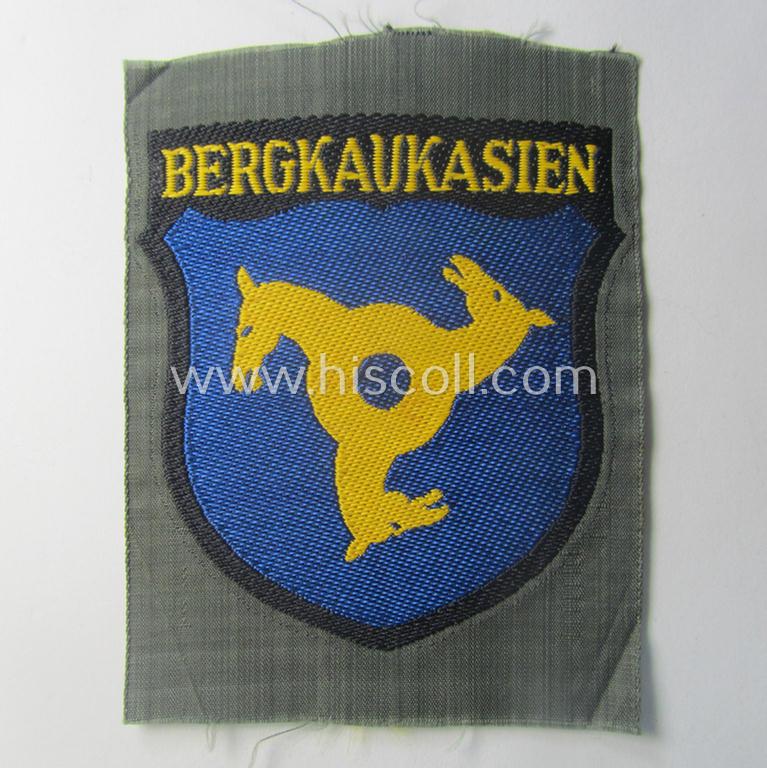 'BeVo'-type armshield (of the second pattern!) entitled: 'Bergkaukasien', being a piece as intended for a volunteer who served within the 'Deutsche Wehrmacht' ie. within the 'Berg- o. Nord-Kaukasisches Legion'