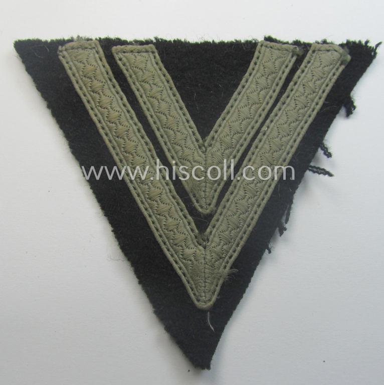 Truly used- and/or tunic-removed, Waffen-SS- (ie. Heeres Panzer-) type 'Armwinkel' (or: rank-chevron) as executed on black-coloured wool as was intended for an: 'SS-Rottenführer' (ie. 'Obergefreiter')