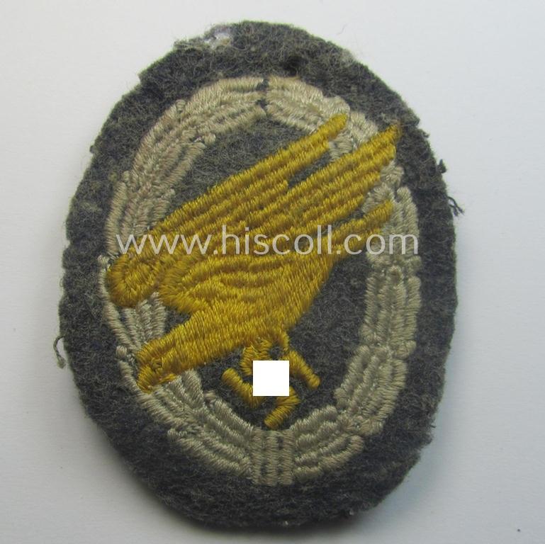 Truly worn WH (Luftwaffe) 'Fallschirmschützen-Abzeichen in Stoff' (or: cloth-based paratroopers' jump-badge) that is nicely machine-embroidered and being of the so-called: 'padded version'